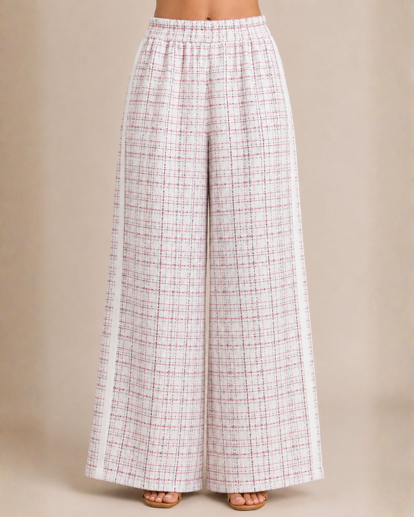 Plaid wide-leg pants on a beige background