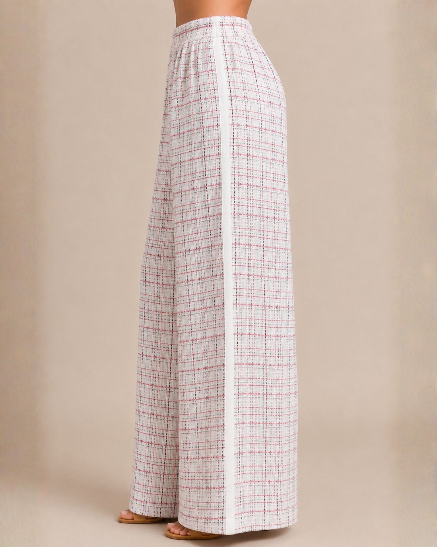 Plaid pants worn by a person on a beige background