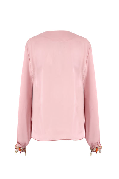 Pale rose Armani satin tie-front crop top with hand-applied shell and bead cuffs, worn with black wide-leg trousers — Bardees Riad Tie Crop (توب رياض).